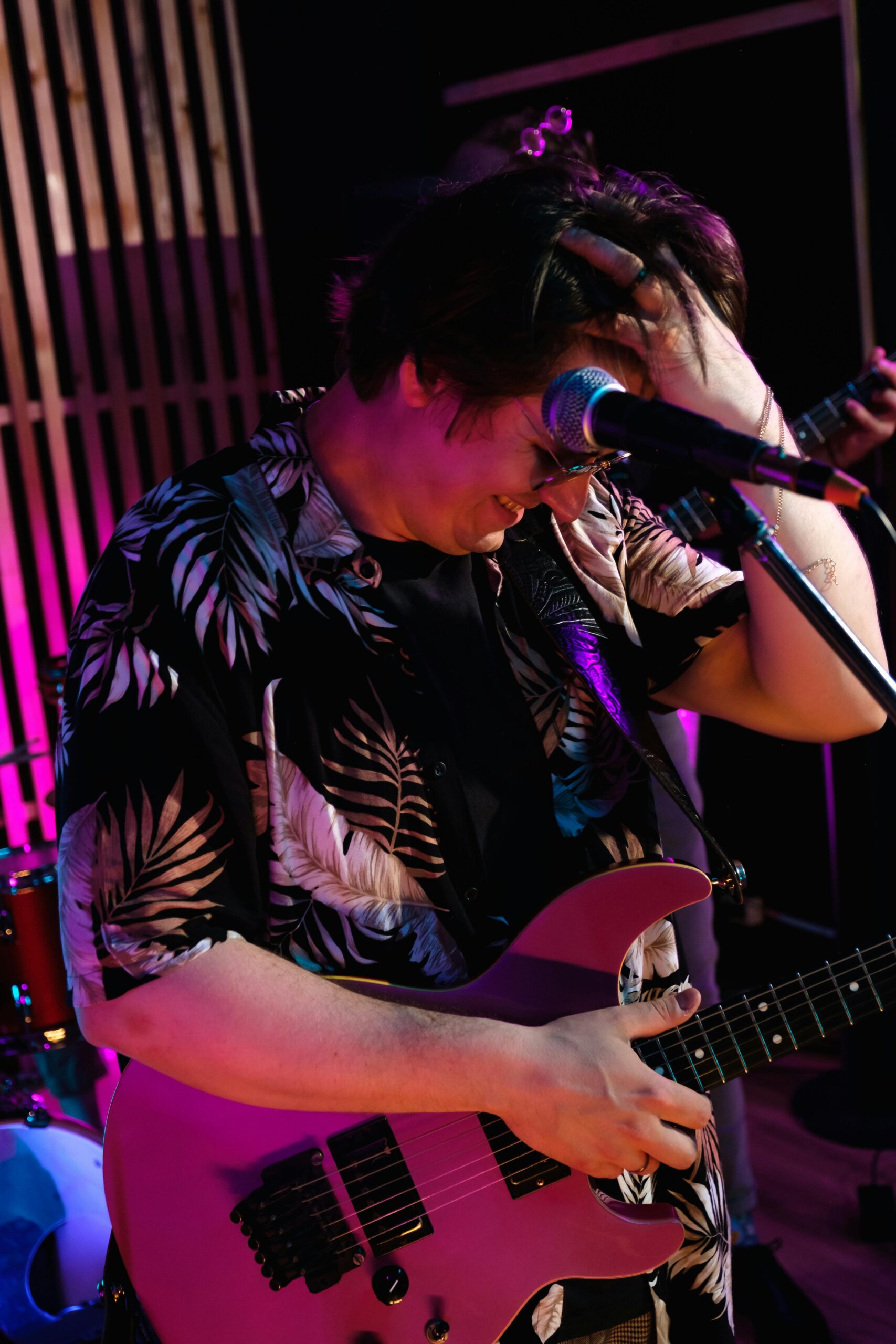 Engaging live performance with a guitarist passionately playing under vibrant stage lights.